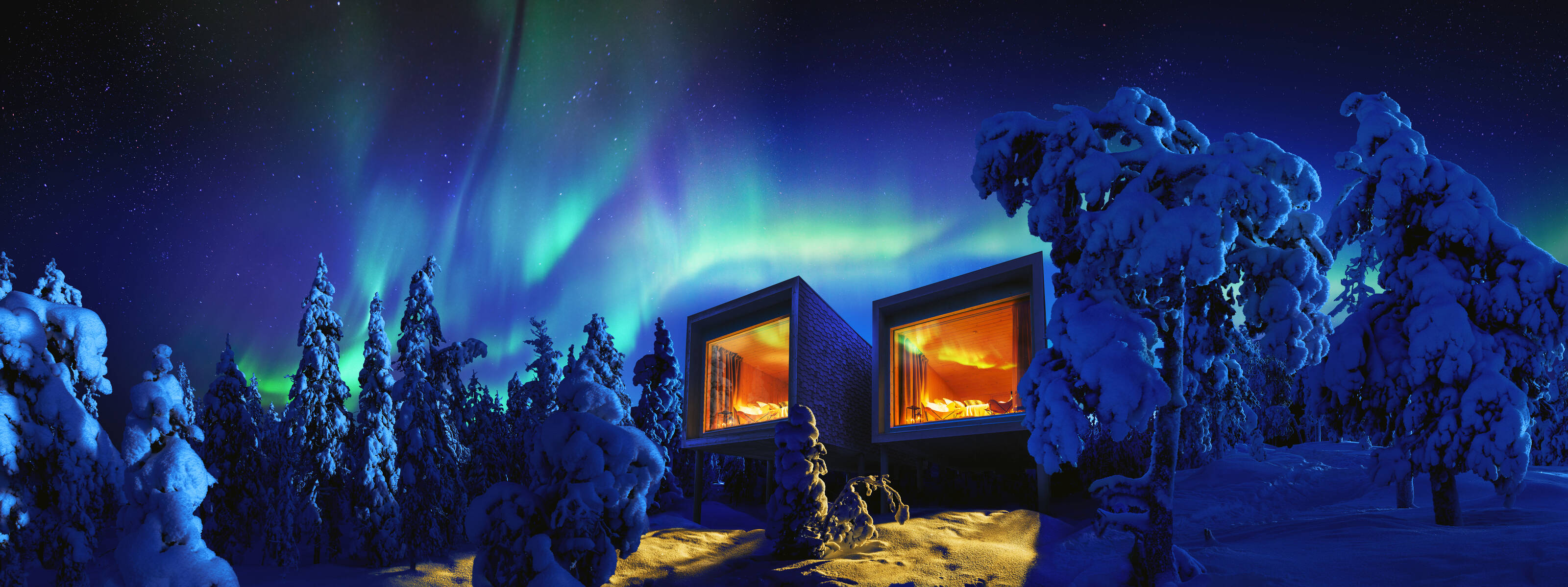 Luxury hotel rooms with a panoramic view on the surroundings with huge bay windows under the Northern Lights in a Forest near the Arctic Circle.